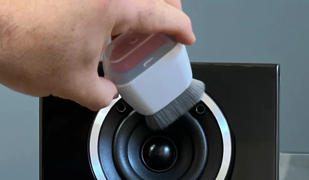 use a brush to clean speakers
